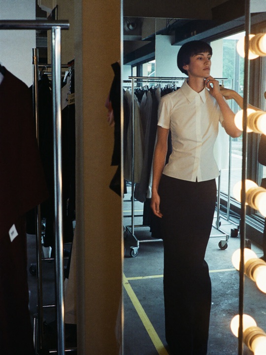 Backstage — Runway backstage — mirrors, tape marks, mixed light